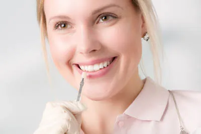 woman choosing the color she'd like for dental veneers at Strawberry Village Dental Care