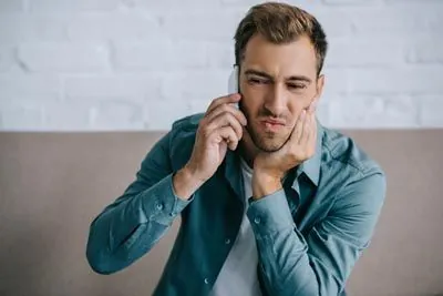 man scheduling an emergency dental appointment at Strawberry Village Dentist