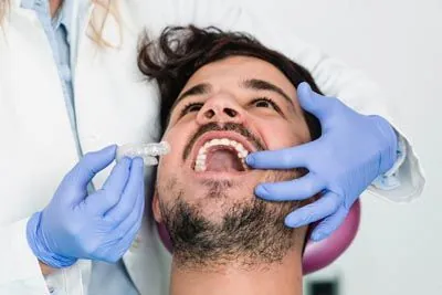 patient being fitted for his new Invisalign clear aligners